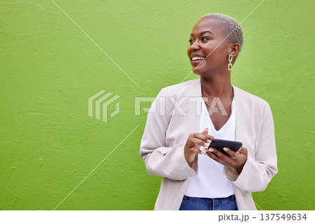 Woman, thinking and phone for communication by a wall or green background with internet. Happy African female person outdoor with a smartphone for social media, networking app and chat mockup space Woman, thinking and phone for communication by a wall or green background with internet. Happy African female person outdoor with a smartphone for social media, networking app and chat mockup space 137549634