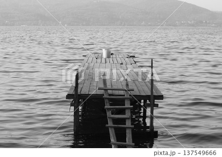 Old abandoned wooden fishing pier on the river in the countryside 137549666