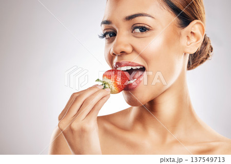 Woman, eating strawberry and skincare portrait, beauty or eco friendly product and natural cosmetics in studio. Happy person, face and red fruit for vegan makeup or dermatology on a white background Woman, eating strawberry and skincare portrait, beauty or eco friendly product and natural cosmetics in studio. Happy person, face and red fruit for vegan makeup or dermatology on a white background 137549713