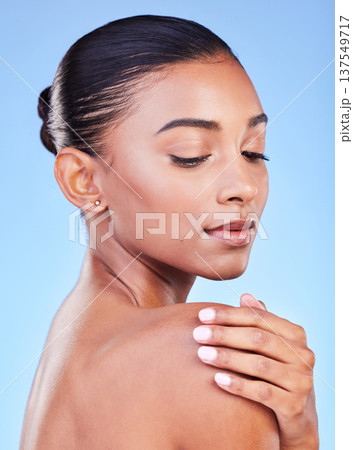 Woman, natural beauty and relax with skincare, face cleaning and skin glow in studio. Facial, female model and cosmetics with dermatology, self care and collagen treatment with blue background Woman, natural beauty and relax with skincare, face cleaning and skin glow in studio. Facial, female model and cosmetics with dermatology, self care and collagen treatment with blue background 137549717