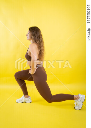 Young woman practicing lunge exercise for fitness training Young woman practicing lunge exercise for fitness training 137550105