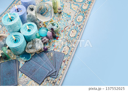 Divination tools with tarot cards and burning candles 137552025