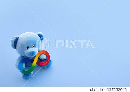 Blue teddy bear holding rainbow neurodiversity infinity symbol Blue teddy bear holding rainbow neurodiversity infinity symbol 137552043