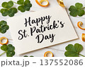 St. Patrick's Day Greeting Card with Shamrocks and Gold Ribbon on White Wood 137552086