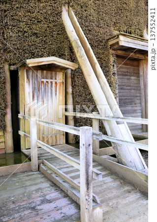 A wooden door and ramp against a wall of cooling tower branches A wooden door and ramp against a wall of cooling tower branches 137552411