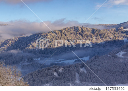 Looking out over the snowcapped valley in the golden hour Looking out over the snowcapped valley in the golden hour 137553692