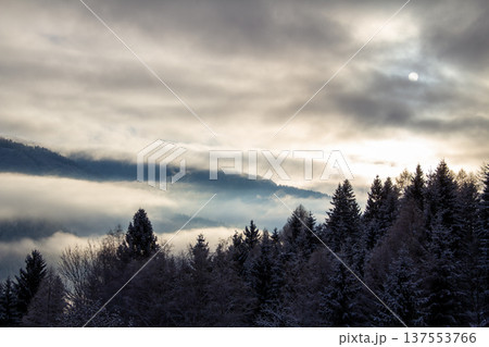 Sunrise makes a breakthrough in the mist between the mountains 137553766
