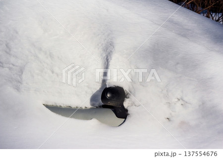 Right mirror of a car buried in heavy winter snow, emerging from a thick white blanket. Cold weather, seasonal transportation challenge Right mirror of a car buried in heavy winter snow, emerging from a thick white blanket. Cold weather, seasonal transportation challenge 137554676