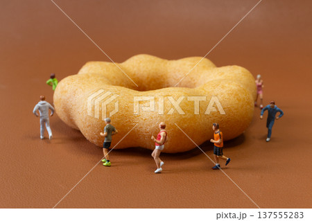Miniature Joggers Running Around Donut Healthy Lifestyle Concept 137555283