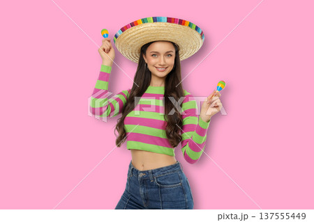 Cinco de Mayo, A young woman wears a sombrero and holds maracas Cinco de Mayo, A young woman wears a sombrero and holds maracas 137555449