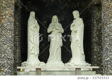 Statues of three figures stand in a stone temple in Bali Statues of three figures stand in a stone temple in Bali 137555515