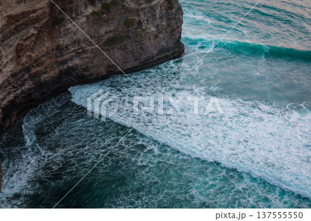 Waves crash against rocky cliffs along Balis coastline 137555550