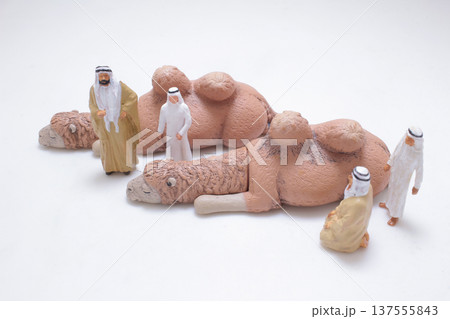 Miniature camels displayed before group of desert figures 137555843
