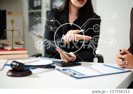 AML Anti Money Laundering Financial Bank Business Concept. judge in a courtroom using laptop and tablet with AML anti money laundering icon on virtual  screen. 137556153