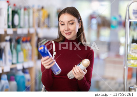 Young woman choosing aerosol in store 137556261