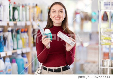 Woman choosing toothpaste in supermarket Woman choosing toothpaste in supermarket 137556343