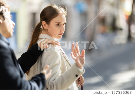 Young guy trying to meet woman getting rejected on street 137556368