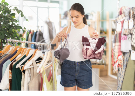 Young woman chooses underwear in clothing store 137556390