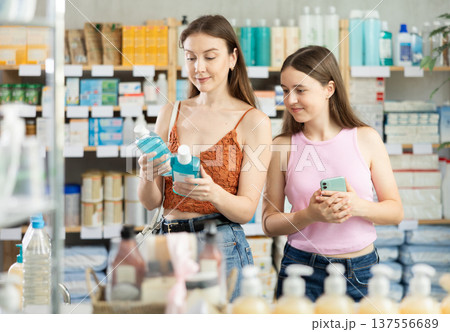 Woman with girl child buyer select mouthwash 137556689