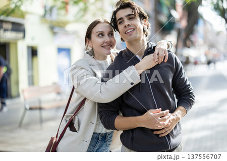 Young couple hugging each other on city street 137556707