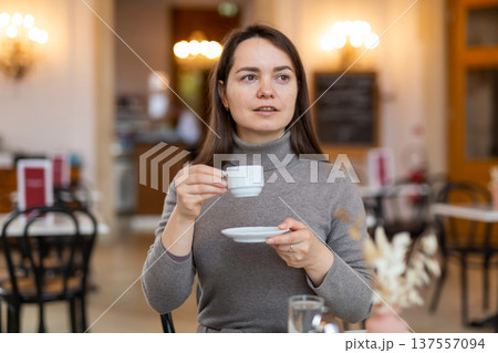 Female tourist enjoying cup of espresso in Viennese coffee house 137557094