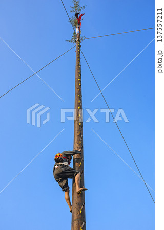 Traditional ladder climbing activity, climbers ascend step by step. Traditional ladder climbing activity, climbers ascend step by step. 137557211