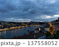 Twilight Over Riverside Cityscape with Illuminated Historic Waterfront 137558052