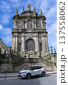Historic Baroque Church Facade with Modern Car Parked Beneath Blue Sky 137558062