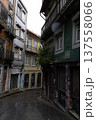 Narrow Cobblestone Street with Old Buildings and Graffiti Urban Scene 137558066