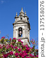 Historic Bell Tower Against Clear Blue Sky with Vibrant Pink Blossoms 137558076
