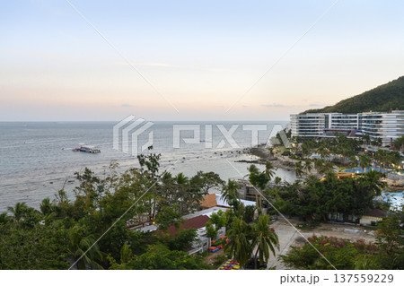 Sunrise over Dadonghai Bay in tropical Sanya City on Hainan Island in China Sunrise over Dadonghai Bay in tropical Sanya City on Hainan Island in China 137559229