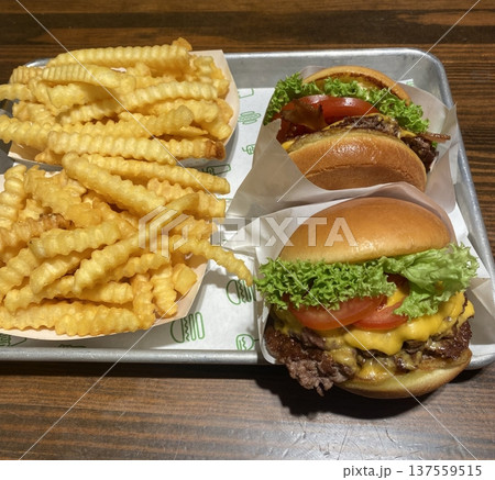 A classic combination of a juicy burger with fresh toppings served alongside golden, crispy French fries. Perfect for a satisfying meal that blends savory flavors and crunchy textures. A classic combination of a juicy burger with fresh toppings served alongside golden, crispy French fries. Perfect for a satisfying meal that blends savory flavors and crunchy textures. 137559515