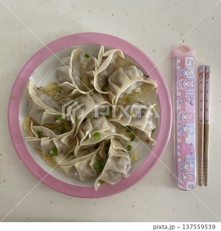 Korean dumplings filled with a mix of savory ingredients like ground meat, tofu, and vegetables. Mandu can be steamed, boiled, or pan-fried, making it a versatile and delicious snack or meal. 137559539