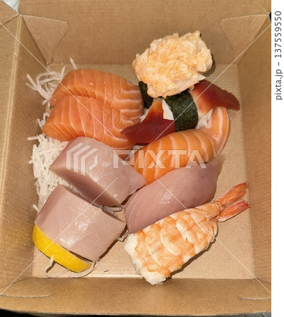 An assortment of fresh sushi, artfully arranged with a variety of toppings and vibrant colors. This traditional Japanese dish combines vinegared rice, seafood, and vegetables for an experience. 137559550