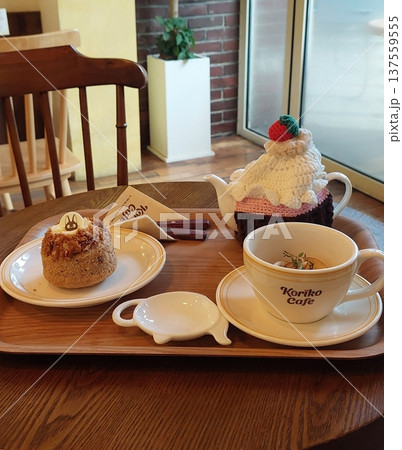 A delightful assortment of desserts displayed in a cozy cafe setting, featuring cakes, pastries, and sweet treats on elegant plates, creating a warm and inviting atmosphere. A delightful assortment of desserts displayed in a cozy cafe setting, featuring cakes, pastries, and sweet treats on elegant plates, creating a warm and inviting atmosphere. 137559555