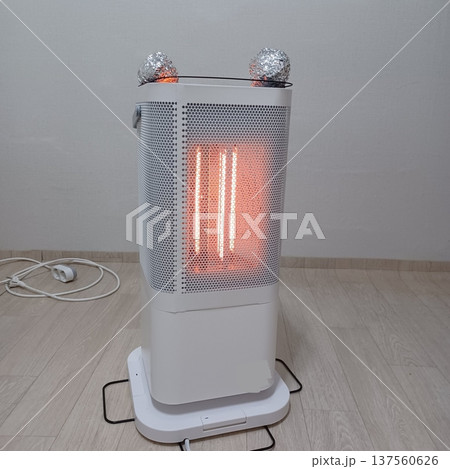 Portable heater with compact design and visible vents, emitting warm air to provide comfort indoors, combining practical function with a simple appearance suitable for home or office use 137560626