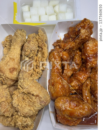 Crispy Korean fried chicken, perfectly glazed with a sweet and spicy sauce. Ideal for food photography and menus, showcasing the irresistible crunch and flavor of this beloved dish. Crispy Korean fried chicken, perfectly glazed with a sweet and spicy sauce. Ideal for food photography and menus, showcasing the irresistible crunch and flavor of this beloved dish. 137560650