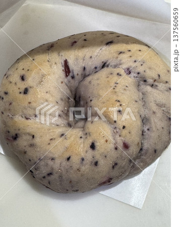 A freshly baked bagel with a golden-brown crust and soft, chewy interior. Perfect for pairing with cream cheese, smoked salmon, or enjoyed simply toasted. 137560659