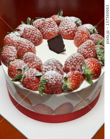 Strawberry cake with soft fluffy layers, topped with fresh strawberries and smooth cream, showcasing vibrant red fruit, delicate textures, and sweet inviting appearance in close-up detail Strawberry cake with soft fluffy layers, topped with fresh strawberries and smooth cream, showcasing vibrant red fruit, delicate textures, and sweet inviting appearance in close-up detail 137560663