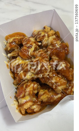 Crispy Korean fried chicken, perfectly glazed with a sweet and spicy sauce. Ideal for food photography and menus, showcasing the irresistible crunch and flavor of this beloved dish. Crispy Korean fried chicken, perfectly glazed with a sweet and spicy sauce. Ideal for food photography and menus, showcasing the irresistible crunch and flavor of this beloved dish. 137560699