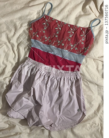Stack of neatly folded clothes in various colors and fabrics, showing layered textures, soft materials, and stylish casual outfits prepared for daily wear, highlighting a trendy OOTD concept in detail 137560716