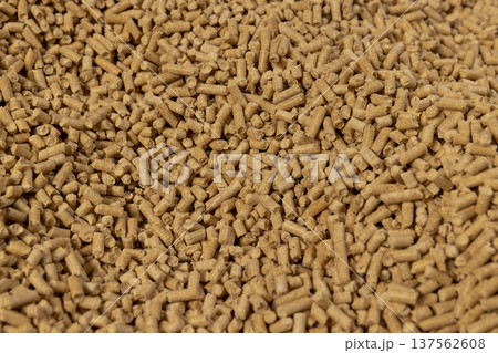 a large number of cylindrical fuel pellets made from sawdust of coniferous or pine trees, the pellets are used both for indoor heating and for bedding for pets, wood pellets a large number of cylindrical fuel pellets made from sawdust of coniferous or pine trees, the pellets are used both for indoor heating and for bedding for pets, wood pellets 137562608