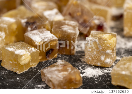 soft and fresh Turkish delight sprinkled with a small amount of powdered white sugar, sweet white soft pieces of Turkish delight with nuts and dried fruits, yellow-orange sweetness 137562620