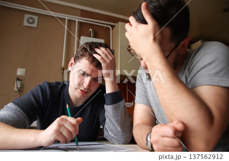 Close-up of an architect team planning a project. a man hand drawing a professional design with a pencil in the office. Brainstorm men concept Close-up of an architect team planning a project. a man hand drawing a professional design with a pencil in the office. Brainstorm men concept 137562912