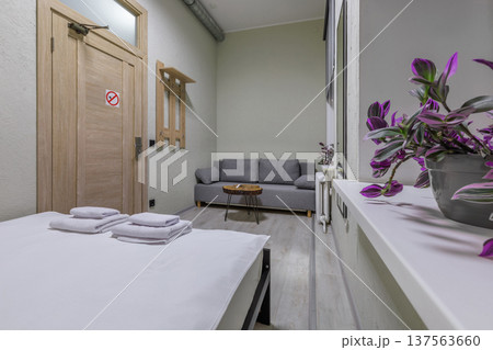 Modern Functional Hostel Room with Grey Sofa and Double Bed Modern Functional Hostel Room with Grey Sofa and Double Bed 137563660