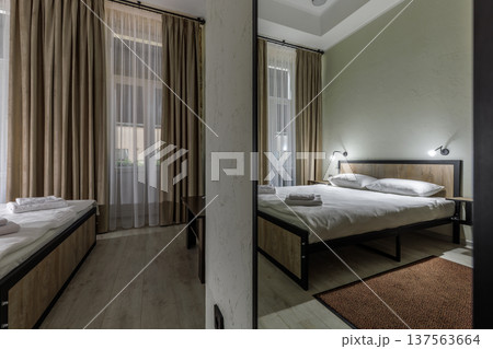 Double Bed in Minimalist Hotel Room with Mirror Reflection Double Bed in Minimalist Hotel Room with Mirror Reflection 137563664