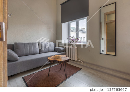 Compact Lounge Area in Modern Hostel with Sofa and Slab Table Compact Lounge Area in Modern Hostel with Sofa and Slab Table 137563667