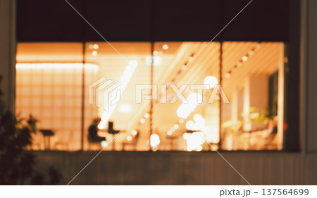 Defocused image of cafe or restaurant interior at night with golden bokeh lights abstract background 137564699