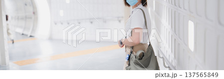 solo asian woman wearing protective mask during transport to work or travel solo asian woman wearing protective mask during transport to work or travel 137565849