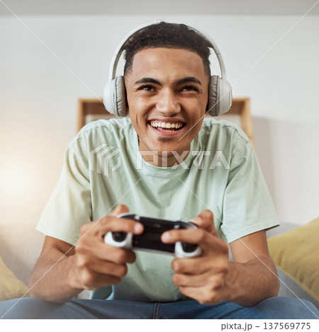 Happy, game controller and man with headphones, listening or relax on a sofa, connection or internet. Person, gamer or guy playing online, home or headset with sound, happiness or console for esports Happy, game controller and man with headphones, listening or relax on a sofa, connection or internet. Person, gamer or guy playing online, home or headset with sound, happiness or console for esports 137569775